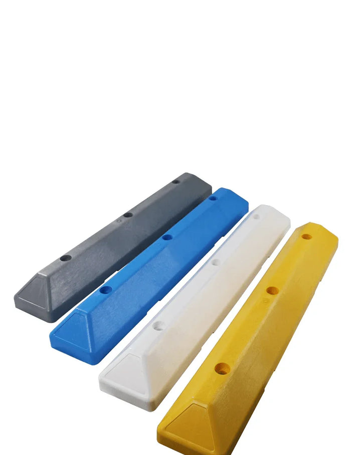 Set of four recycled plastic parking blocks in gray, blue, white, and yellow with mounting holes.