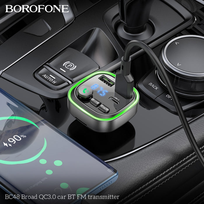 Close-up of BOROFONE BC48 Broad QC3.0 car Bluetooth FM transmitter plugged into a vehicle's dashboard with digital display