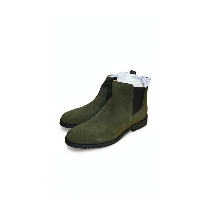 Chelsea boots featuring elastic side gores and a slim black sole.