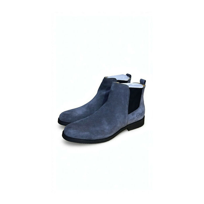 Chelsea boots featuring elastic side gores and a slim black sole.