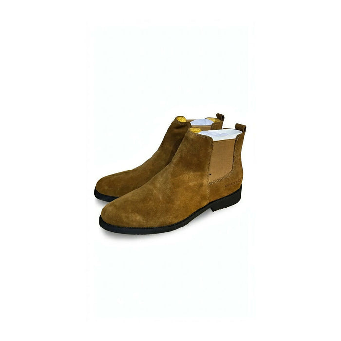 Chelsea boots featuring elastic side gores and a slim black sole.