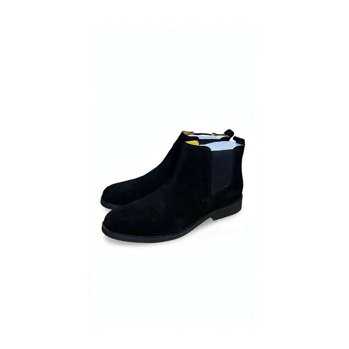 Chelsea boots featuring elastic side gores and a slim black sole.
