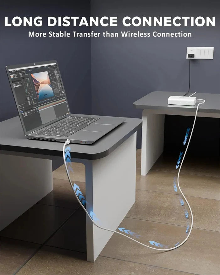 Laptop on a desk with a cable running along the floor, emphasizing long-distance connection.