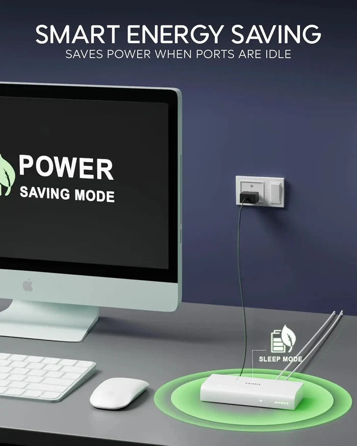 Computer setup with power saving mode display and smart energy saving device on desk.