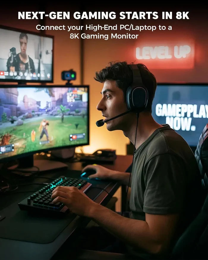 Person playing a video game on a high-end PC with 8K graphics, surrounded by gaming equipment.