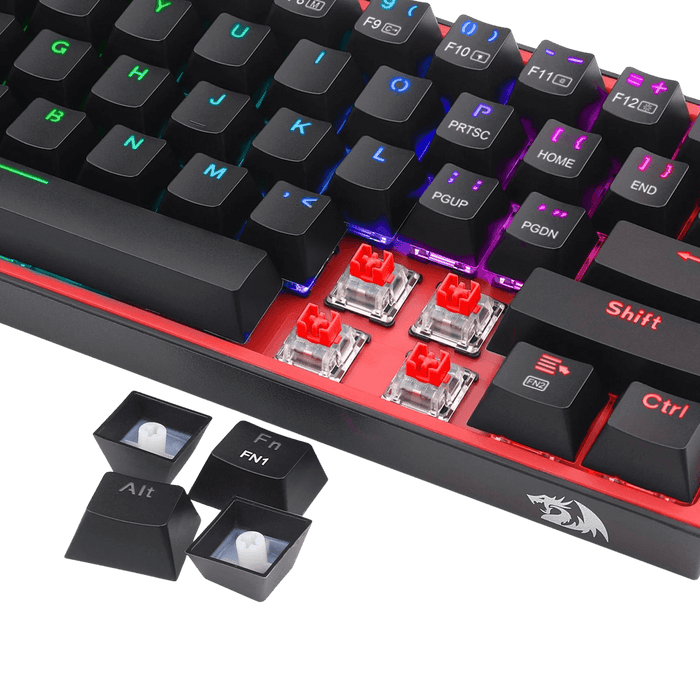 A close-up of a mechanical keyboard with black keycaps, red switch housings, and RGB backlighting, shown on a black background with two removable keycaps placed in front.
