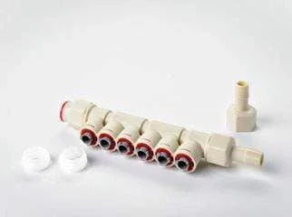 Injector spider system manifold with six ports, connectors, and white fittings on a plain background