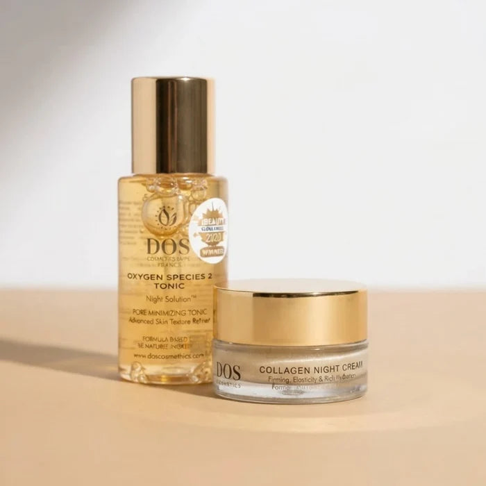 A bottle of DOS Cosmetics Oxygen Species 2 mandelicum solution and a jar of Collagen Night Cream, both with gold caps, displayed on a light beige surface against a white background.