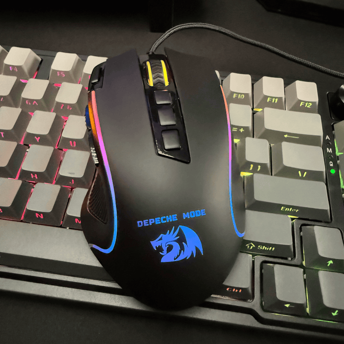 Redragon Gaming mouse with RGB lighting on a keyboard