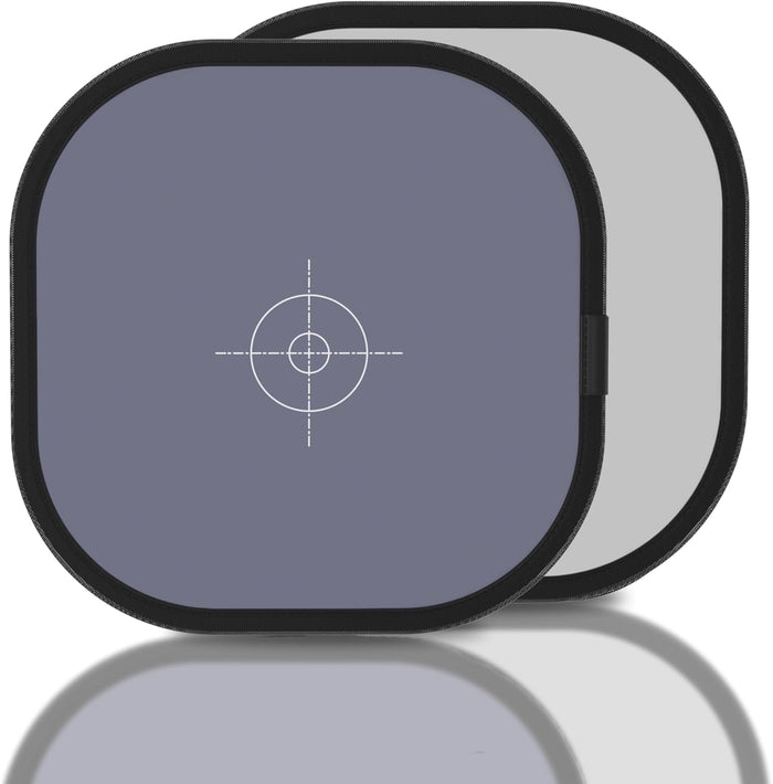 Two square filters with a central crosshair design on a reflective surface.