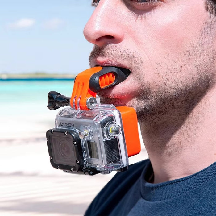 Close-up of a man using an orange and black GoPro mouth mount on the beach, ideal for hands-free POV filming.