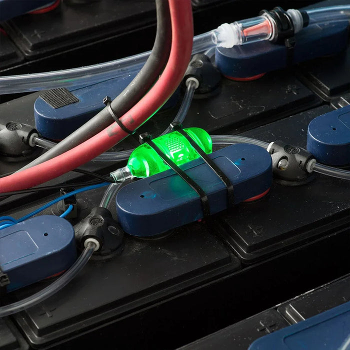 Battery water monitoring system with green indicator light on industrial battery cells