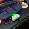 Battery watering monitor with green LED indicator and connected power cables