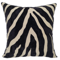 Zebra patterned pillow with black and beige stripes on a white background