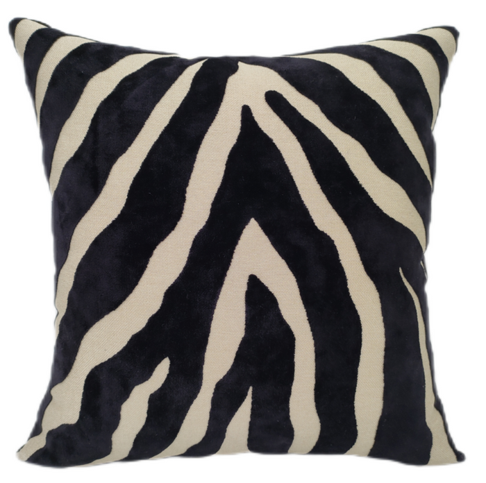 Zebra patterned pillow with black and beige stripes on a white background